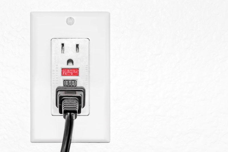 Ground fault circuit interrupter red reset and black test button to prevent electric shock.