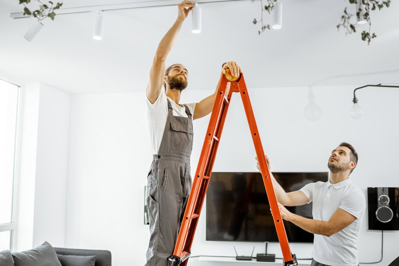 Does Your Home Need an Electrical Panel Upgrade? An electrician fixing a light.