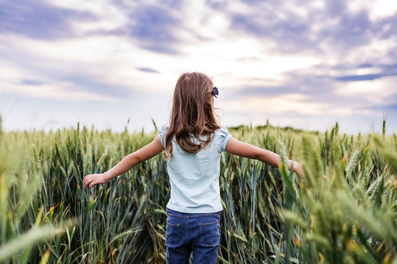 5 Electrical Tips to Save Money. Photo of a young female child in the middle of a field during the day.