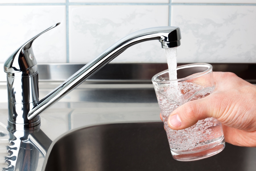 Hand holding a glass of water