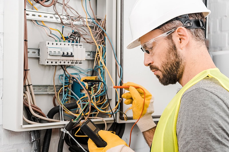 What to Expect During an Electrical Inspection. An electrician doing an inspection.